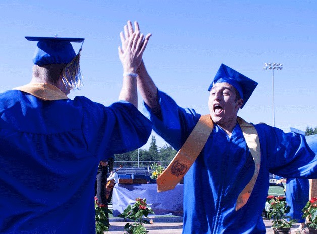 Paimon Jaberi high fives Spencer Hogger after receiving their diplomas on Saturday