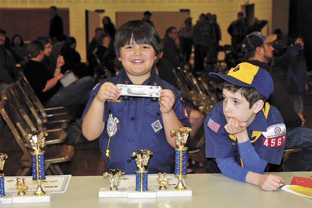Cort Satterwhite of Bainbridge Island displays his Pinewood Derby racer that helped him win first place at the Pinewood Derby Districts in Silverdale.