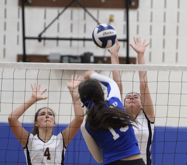 Erika Mattes and Riley Kulfan rise to block a shot during action against Seattle Prep.