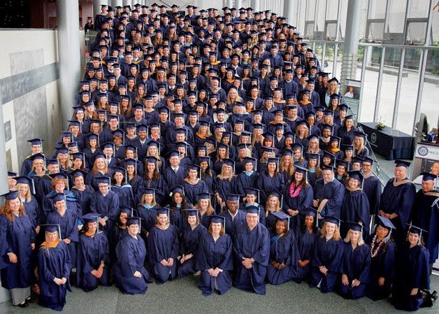 New graduates of WGU Washington gather for a photo at their commencement ceremony at McCaw Hall.