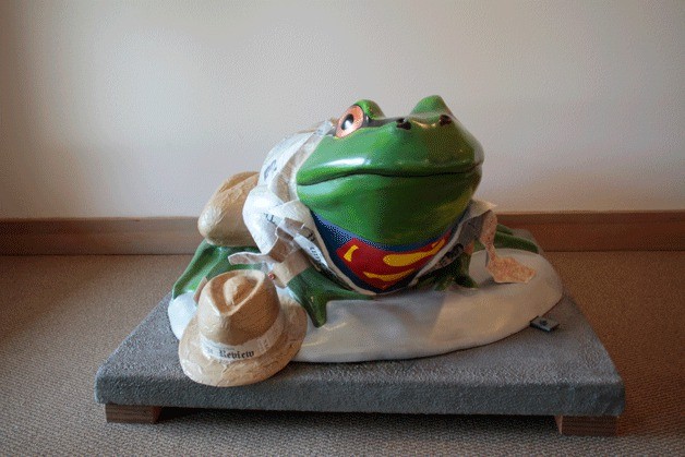 The Bainbridge Review's 'Clark Kent Frog' sits in the lobby of the 911 Hildebrand Lane building