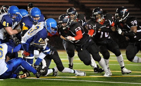 BHS running back Alex Crane blasts through the Lindberg line during playoff action Friday in Renton.