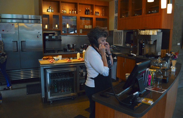 BIMA Bistro server Elaine Greene takes a call before the dinner service begins.