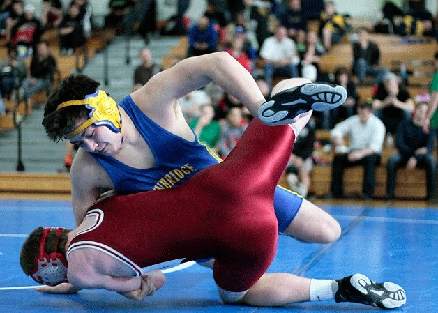 Spartan heavyweight Mike Grant grapples with Joey Kane from Kingston High in the 32nd Island Invitational wrestling tournament in the Bainbridge High gymnasium Saturday
