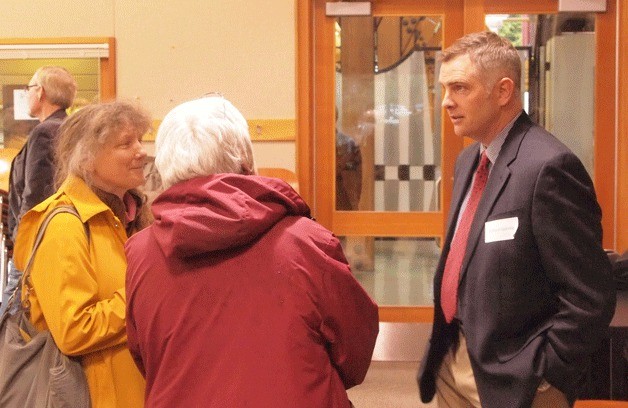 Richard Goerling talks with islanders at a meet and greet April 4.