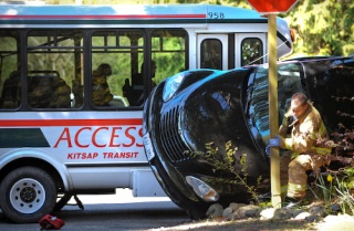 Bainbridge Fire personnel prepare to remove the driver of an SUV that collided with a Kitsap ACCESS bus Tuesday.