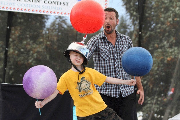 Gavin Brown takes center stage as a volunteer from the audience for the Matt Baker Comedy Juggler Show — under Baker's watchful eye — during a Saturday performance at the Kitsap County Fair.