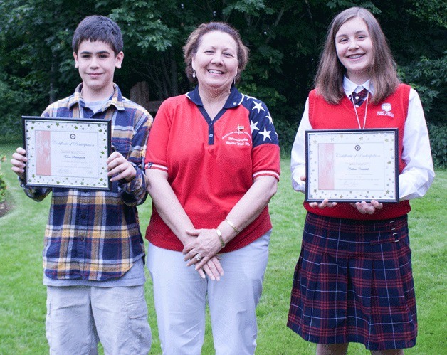 Ethan Soltanzadeh and Colleen Campbell stand with their awards with American Legion Auxiliary Unit 172 member Cindy McCarthy.