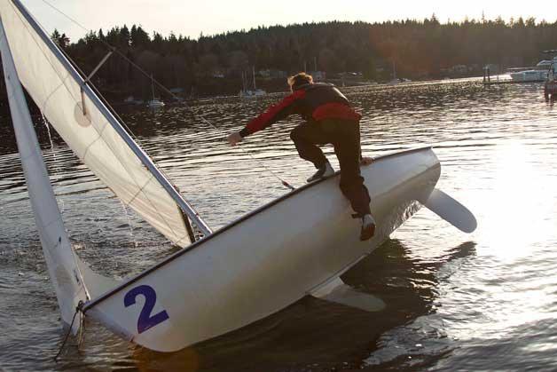 Students on the Bainbridge High School sailing team struggled through capsize drills during the initial days of practice on the water
