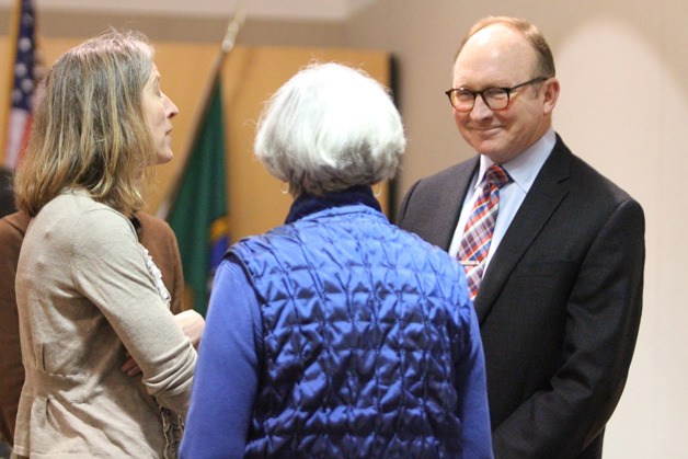 Newly appointed councilman Michael R. Scott talks with Deputy City Manager Morgan Smith and Mayor Anne Blair after his appointment.