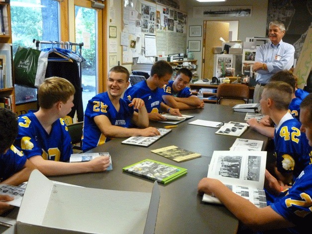 The current roster of Bainbridge High School football players made their annual early-morning pilgrimage to the Bainbridge Island Historical Museum last week to learn about the history of the island and notable past Spartans.
