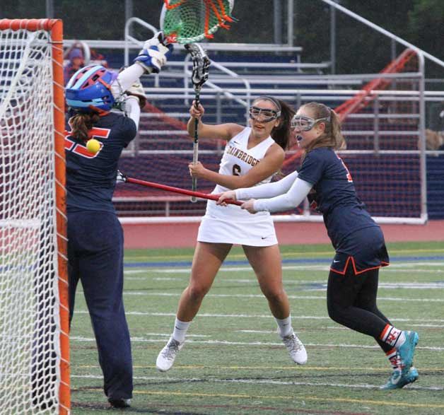 Bainbridge’s Sonia Olson fires a shot past the right shoulder of goalie Court Huston during the Spartans’ big win over Eastside Catholic.