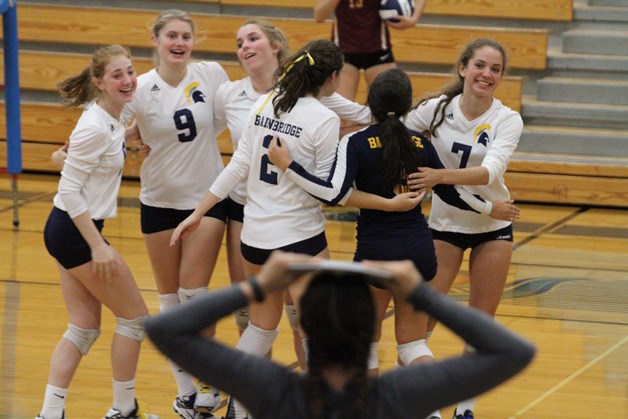 The Spartans celebrate after winning a rally against Kingston Wednesday in Paski Gymnasium while new Coach Holly Rohrbacher reacts from the sideline. The Spartans won in four
