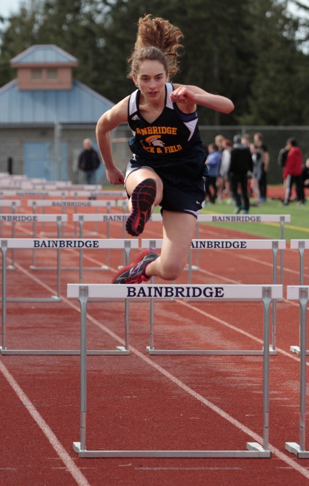 Sophie Wickstrom dashes through the girls 100-meter hurdles at the first home track meet of the season.