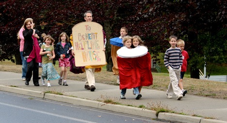 Cross Sound Church members walk from Bainbridge High School to Helpline House to deliver donations. The group dressed up as sandwiches and jars of peanut butter to deliver more than 200 actual containers of peanut butter and jelly