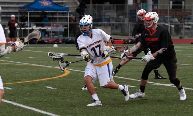 Bainbridge senior lacrosse player Zach Morales looks to regain control of the ball during a scuffle in Tuesday’s match against Eastside Catholic.