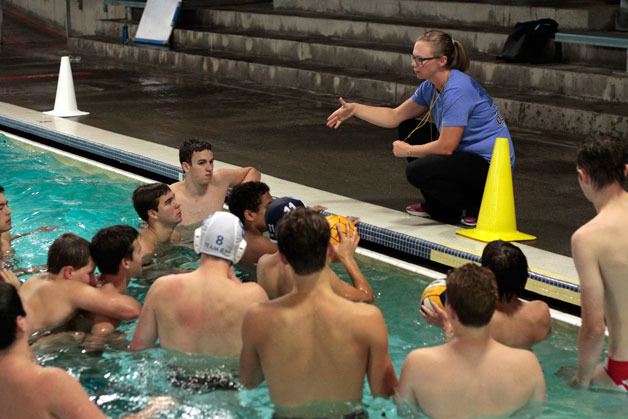 Spartan Head Coach Kristin Gellert talks with the gathered members of the Bainbridge High School boys varsity water polo team at a practice session last week.