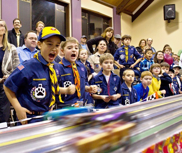 Cub Scouts from Pack 4545 and 4496 cheer on their custom racers at the Bainbridge Island Pinewood Derby.