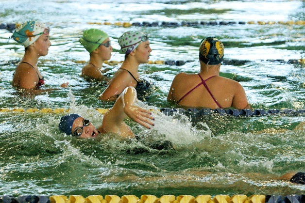 Amanda Comeau completes a lap at the Bainbridge Island Aquatic Center while teammates Alyssa Estes