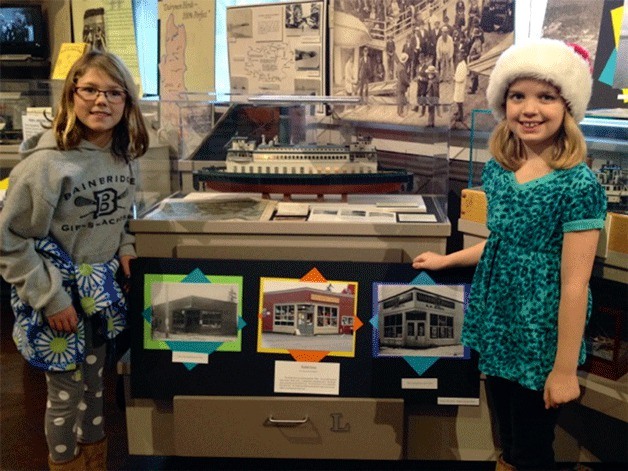 Fourth-graders Gabby Edwards and Samantha Boulware proudly displaying their historical exhibit of Rodal’s Grocery