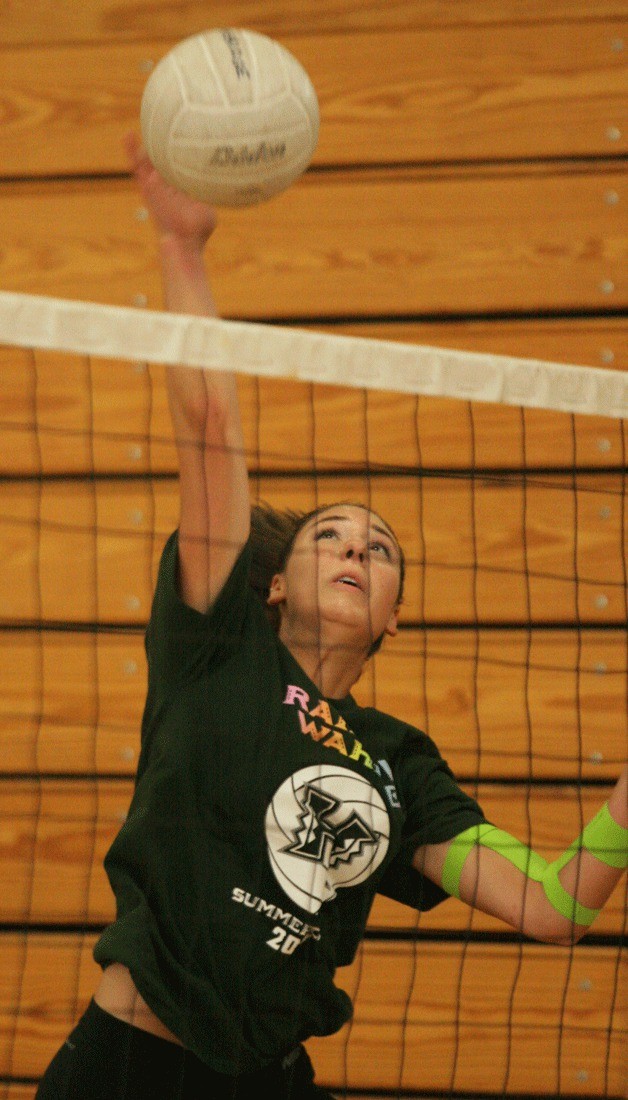 Hannah Wagner spikes the ball during the second day of volleyball tryouts at Bainbridge High. Wagner is a returner from last year's winning team.