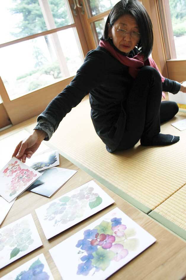 Seraine Page | Bainbridge Island Review Local artist Norimi Kusanagi lays out samples of her cards in her Bainbridge Island home. Kusanagi learned the art of pressing flowers from her sister-in-law in Japan.  Her pressed flower card art is now on display at the Bainbridge Public Library.