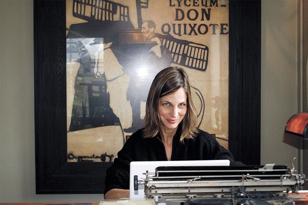 Owner Kirsten Foster poses with an antique Royal typewriter in the Old Boar.