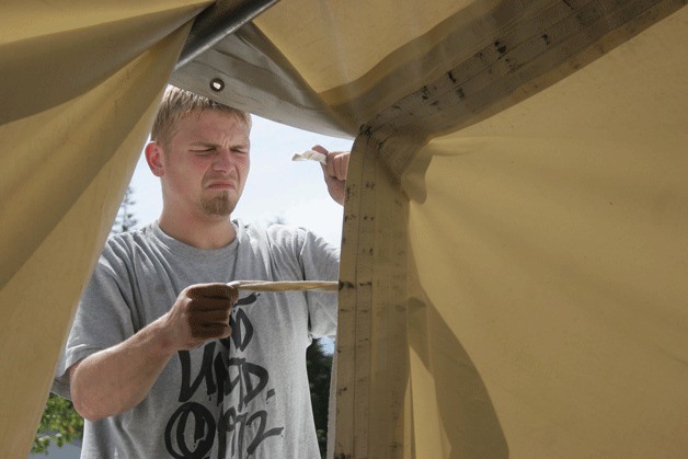 Kyle Hanson of Rowan Event Services struggles to tie down a portion of the circus-style tent that's being raised for this year's Bainbridge Rotary Auction and Rummage Sale.
