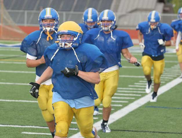 Spartan football players run preseason drills before the start of last season's campaign. The Spartans will return to practice this week.