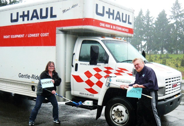 Janice Danielson and Curt Bonderant wash the trucks from each other’s storage company