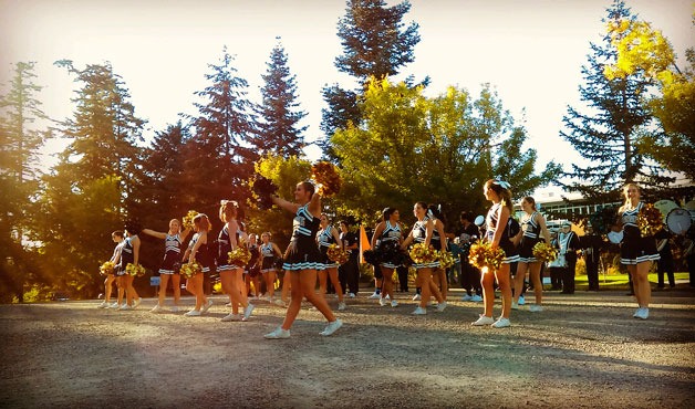 The Bainbridge Spartans cheer staff revs up the crowd at Friday's pre-game tailgate party.