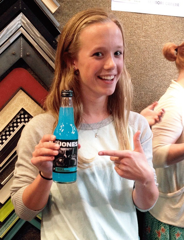 Paige Brigham and a bottle of Jones Soda that sports her award-winning photograph.