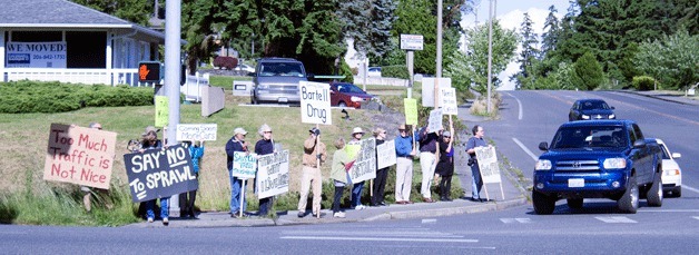 Islanders lined the corner of High School Road and Highway 305 in June to protest a proposed shopping center. A hearing on the development is planned for Thursday
