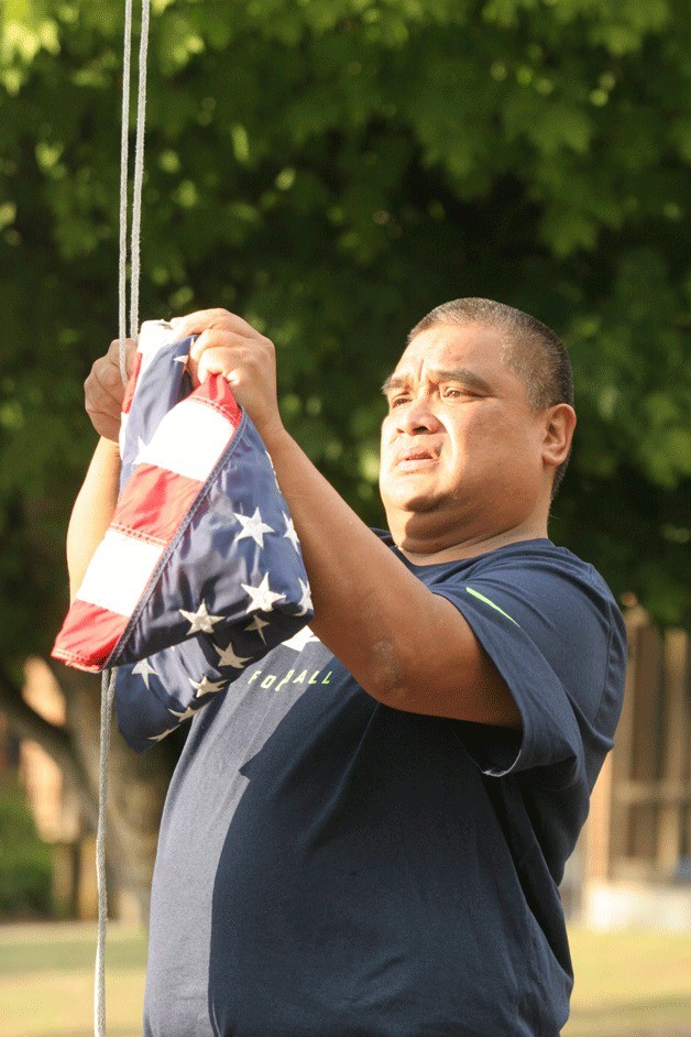 Darrell Rapada raises the flag before the start of the school day at Ordway Elementary.