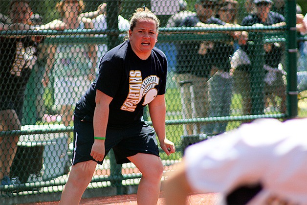 Spartan Coach Liz McCloskey watches a runner dash for first during Bainbridge High’s appearance last year in the state 3A championship fastpitch tournament.