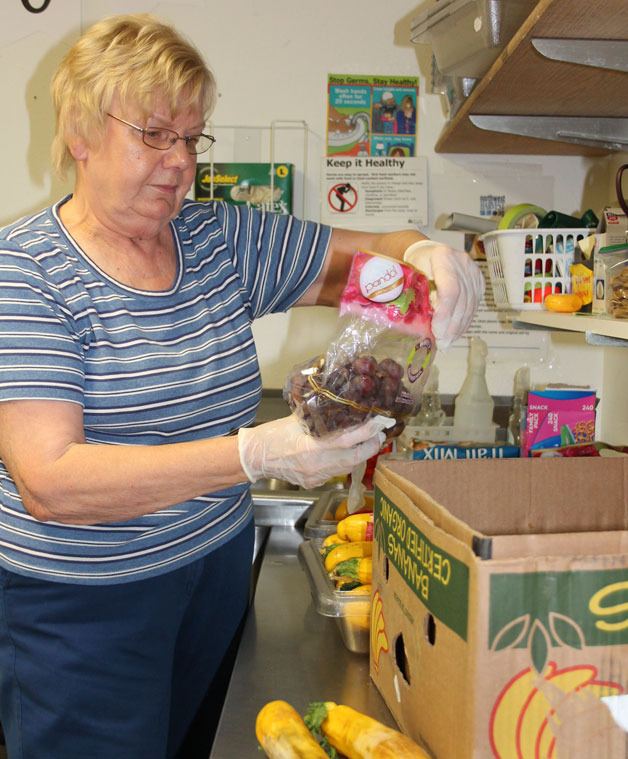 Volunteer Monica Edwards sorts food donations.