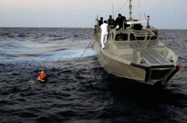 Gary Bracken being tethered into a Mexican Navy vessel to be taken to the nearest hospital.