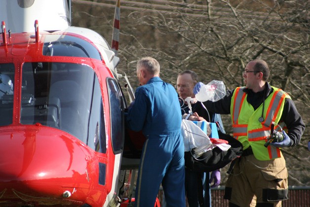 A person who was injured in a two-car crash at the Agate Pass Bridge is loaded into an Airlift Northwest helicopter Monday at the Bainbridge Island Fire Department's station on Madison Avenue.