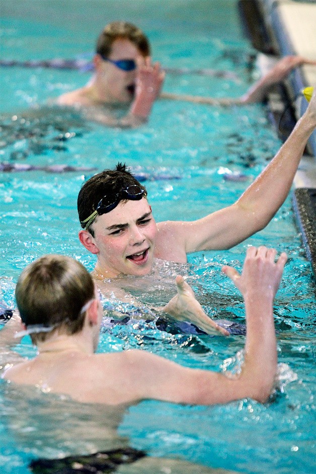 Henry Bacon congratulates teammate Ethan Kutia on a good race at the end of the 200-yard freestyle during the meet against O’Dea late last week.