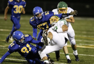 Bainbridge players Sam Snow (left) and James Herman complete a play during a recent game against Bishop Blanchet.