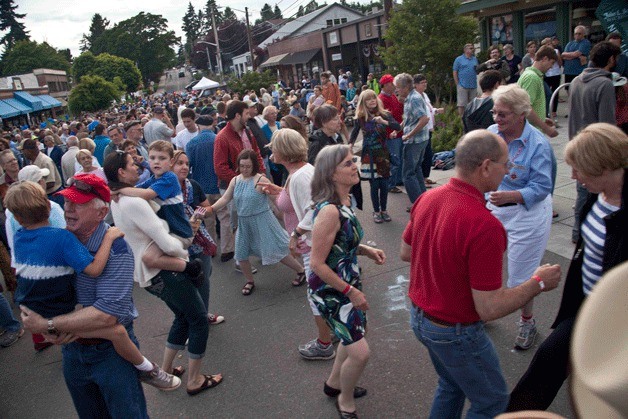 Revelers take to the island's main drag for Winslow's annual street dance on the eve of Independence Day.