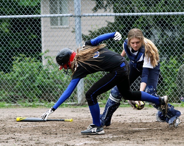 A Seahawk player tries to dance around the tag at home plate as Bainbridge’s  Emma Lindsay gets the out for the Spartans in their win over Chief Sealth.