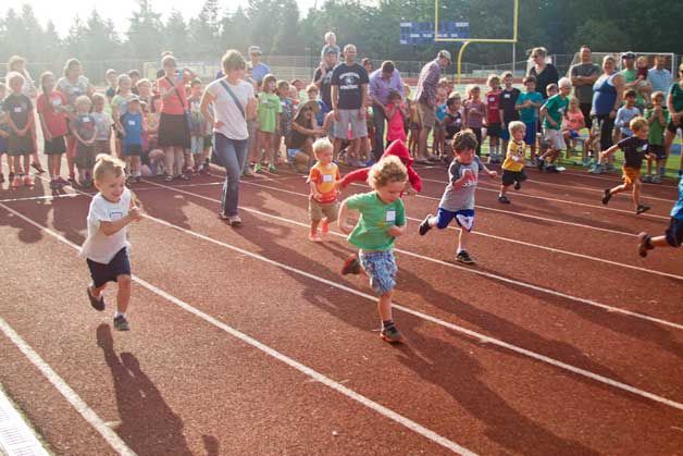 Young runners leap from the starting line at the first All-Comers community track meet Monday. The beloved community tradition returned to Bainbridge High earlier this week