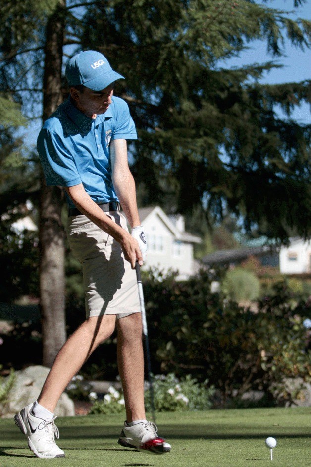 Hudson Hausmann tees off during play against Eastside Catholic at Wing Point Golf Course.
