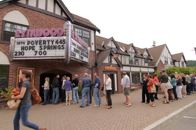 Islanders line up down the street at the Lynwood Theatre to see 'Into Poverty: Living on One Dollar.'