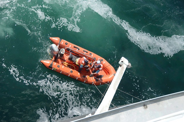 An inflatable rescue raft is hoisted back aboard the ferry M/V Wenatchee after the crew helped search for an overboard woman during the 1:10 p.m. Tuesday sailing to Bainbridge Island.