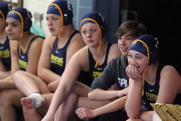 The Spartans watch their teammates battle Newport in girls water polo.