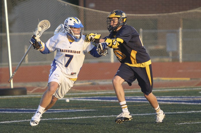 Alex Crane looks for an open man as Bellevue's Riley Pratt defends him. Bainbridge beat the Wolverines 7-6 Friday night to remain undefeated on the season.