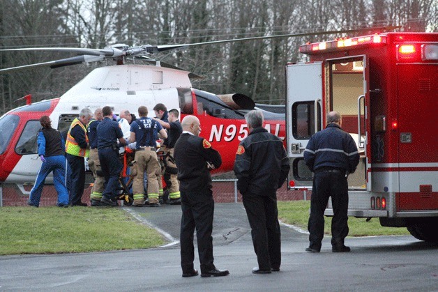A woman who was hit by a car Friday afternoon is loaded aboard an Airlift Northwest medical helicopter at Bainbridge Island Fire Department's Station 21.