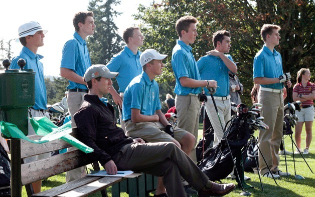 Members of the BHS varsity golf team and Head Coach Joe Lanza (seated) watch as the first player from the visiting Lakeside High team tees off Thursday